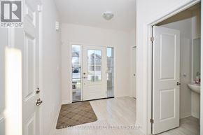 Fort Erie (Ridgeway) apartment for rent - A white hallway with a door leading to a balcony.