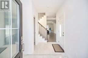 Fort Erie (Ridgeway) apartment for rent - A hallway with a glass door and a staircase.