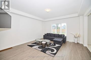 Fort Erie (Ridgeway) apartment for rent - A living room with a grey sofa and a black and white rug.