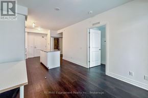 Mississauga (Fairview) condo for rent - A room with white walls and wooden floors, with a white cabinet in the middle.