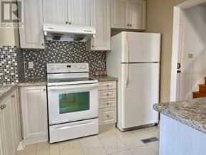 Markham (Markville) apartment for rent - A kitchen with white appliances and cabinets.