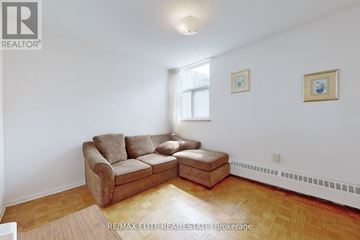 Toronto (Briar Hill-Belgravia) condo for rent - A living room with a couch and a small table.