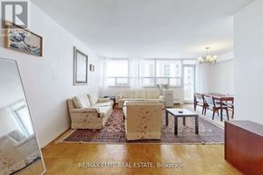 Toronto (Briar Hill-Belgravia) condo for rent - A living room with a couch, chairs, and a rug.