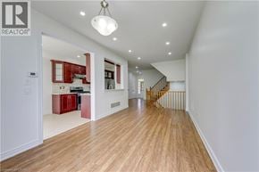 Mississauga apartment for rent - A spacious room with wooden floors and a staircase.