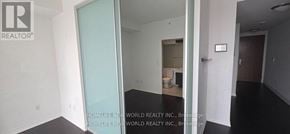 Toronto (Bay Street Corridor) condo for rent - A room with a glass door leading to another room.