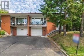 Toronto (Bayview Woods-Steeles) apartment for rent - A two-story brick house with a garage and a balcony on the second floor.