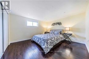 Toronto (Bayview Woods-Steeles) apartment for rent - A bedroom with a bed and a wall-mounted light fixture.