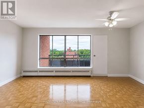 Mississauga (Applewood) condo for rent - A room with a ceiling fan and a window overlooking a brick building.