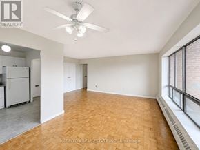 Mississauga (Applewood) condo for rent - A room with a ceiling fan and wooden flooring.