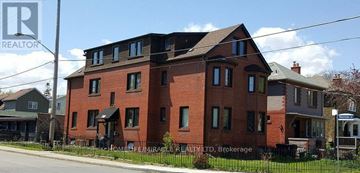 Toronto (Etobicoke West Mall) multi-family for rent - A large red brick house with a sign that says "Realtor" in the background.
