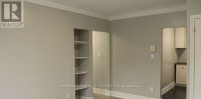 Toronto (Etobicoke West Mall) multi-family for rent - A room with a wall that has a Realtor logo on it.