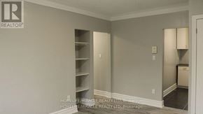 Toronto (New Toronto) multi-family for rent - A room with a brokerage logo on the wall.