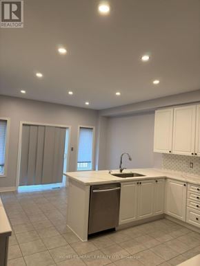 Brampton (Sandringham-Wellington) apartment for rent - A kitchen with white cabinets and a sink.