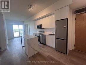 Brantford condo for rent - A kitchen with white cabinets and a marble island.