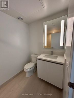 Mississauga (City Centre) condo for rent - A white bathroom with a toilet, sink and mirror.