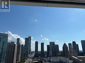 Mississauga (City Centre) condo for rent - A cityscape with tall buildings and a clear sky.