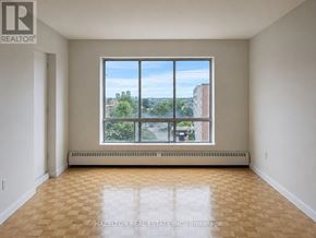 Mississauga (Applewood) condo for rent - A large empty room with a view of the city through the window.