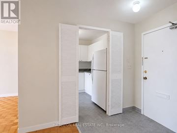 Mississauga (Applewood) condo for rent - A white refrigerator is in a kitchen with white walls.