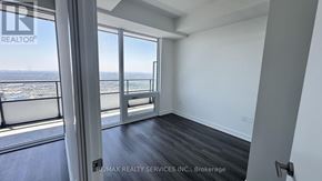 Mississauga (City Centre) condo for rent - A room with a view of the ocean through large windows.