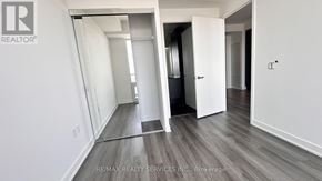 Mississauga (City Centre) condo for rent - A room with a white wall and a wooden floor.