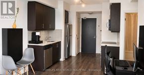 Toronto (Islington-City Centre West) condo for rent - A modern kitchen with dark brown cabinets and a black refrigerator.