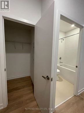 Toronto (South Riverdale) condo for rent - A white door opens to a bathroom with a toilet and a shower.