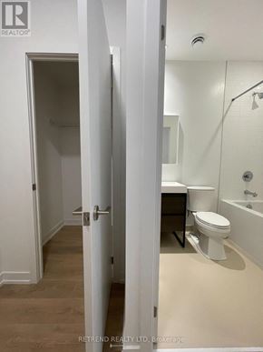 Toronto (South Riverdale) condo for rent - A white bathroom with a toilet, sink and bathtub.