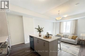 Vaughan (Vaughan Corporate Centre) townhouse for rent - A modern living room with a grey cabinet and a grey sofa.