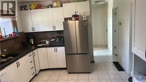 Hamilton apartment for rent - A kitchen with a refrigerator, cabinets, and a counter.