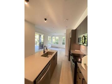Surrey apartment for rent - A modern kitchen with a sink and a window.