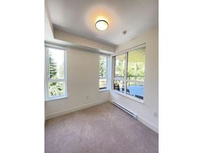 Surrey apartment for rent - A room with a carpet floor and a window overlooking a pool.