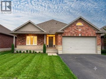 Port Dover apartment for rent - A house with a brown brick facade and a grey garage door.