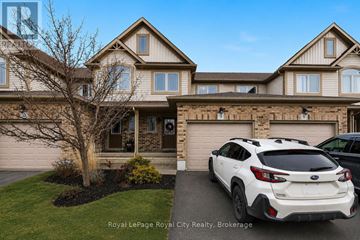 Guelph (Kortright East) townhouse for rent - A white Subaru car is parked in front of a house.