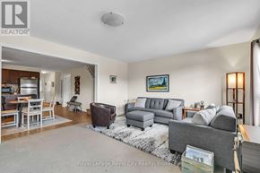 Guelph (Kortright East) townhouse for rent - A living room with a grey couch and a coffee table.