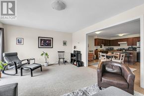 Guelph (Kortright East) townhouse for rent - A living room with a grey carpet and furniture.