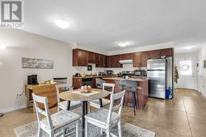 Guelph (Kortright East) townhouse for rent - A kitchen with a table and chairs in the middle of the room.