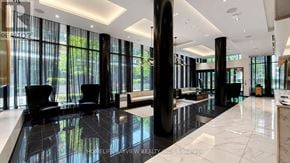 Toronto (Mount Pleasant West) condo for rent - A spacious lobby with black and white decor and a large window.