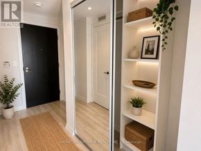 Toronto (Mount Pleasant West) condo for rent - A hallway with a black door and a white door with a plant on the floor.