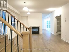 East Gwillimbury (Holland Landing) apartment for rent - A spacious room with a fireplace and a staircase leading to the upper floor.