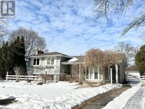 Burlington (Appleby) apartment for rent - A house with a snow-covered ground in front of it.