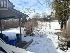 Burlington (Appleby) apartment for rent - A snow-covered yard with a shed and a house in the background.