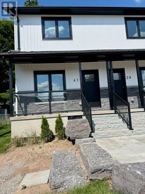 Halton Hills (Georgetown) apartment for rent - A white house with black railings and a black door.