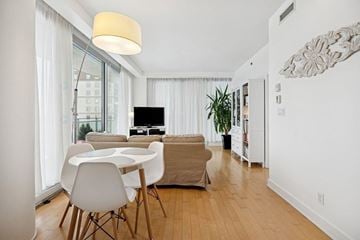 Gatineau (Hull) condo for rent - A modern living room with a white table and chairs.