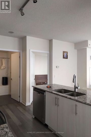 Mississauga (City Centre) condo for rent - A kitchen with a sink and a fridge.