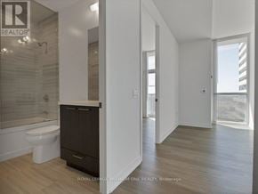 Vaughan (Vaughan Corporate Centre) condo for rent - A bathroom with a toilet, sink, and a shower with a glass door.