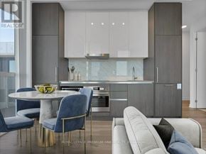 Vaughan (Vaughan Corporate Centre) condo for rent - A modern kitchen with a dining table and chairs.