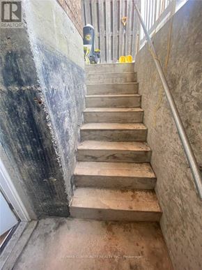 Mississauga (Hurontario) apartment for rent - A staircase with a metal railing and concrete steps.