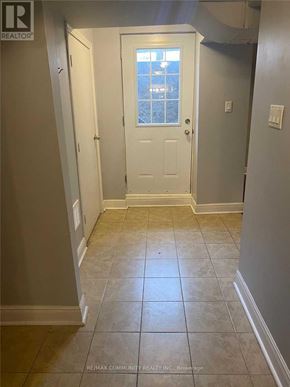 Mississauga (Hurontario) apartment for rent - A hallway with a white door and tiled floor.