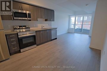 Toronto (Yorkdale-Glen Park) condo for rent - A kitchen with wooden cabinets and stainless steel appliances.