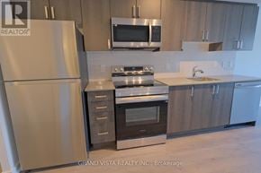 Toronto (Yorkdale-Glen Park) condo for rent - A modern kitchen with a refrigerator, oven, microwave, and sink.